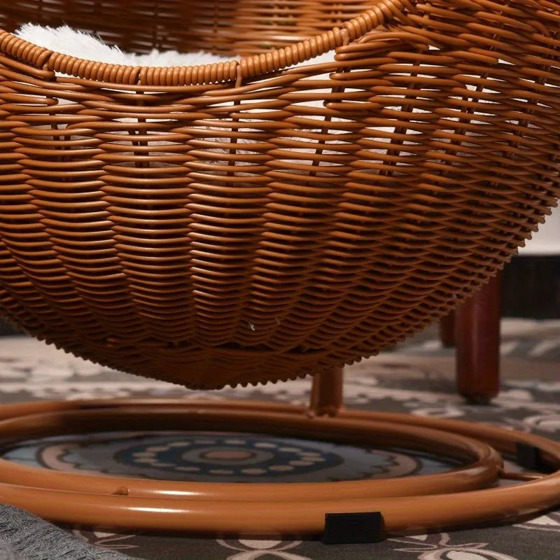 Close-up of the rattan cat swing bed showing the stable double-disc base and non-slip sleeves.